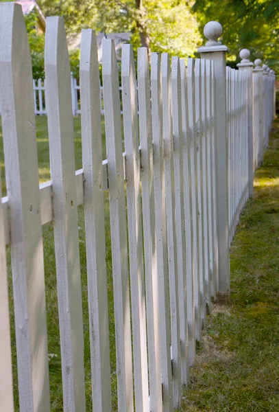 residential white picket fence diminishing in distance