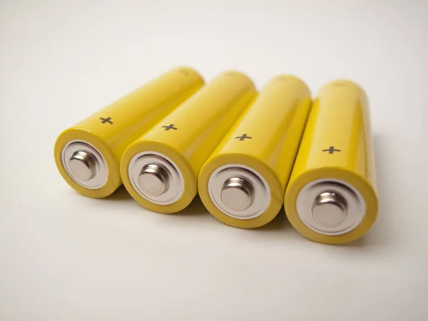 Четыре Желтых Аккумулятора Контактами Знак Плюс Серый Фон — стоковое фото