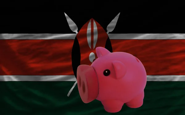 Piggy rich bank in front of national flag of kenya symbolizing saving and accumulating funds as good financial habit