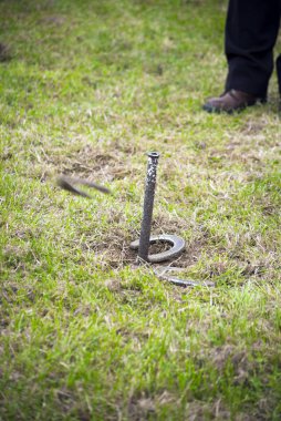 horseshoe pitching competition at a farmers gathering clipart