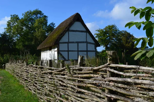 Traditional willow wood wattle fencing running along the boundary of a medieval building in Sussex,England.