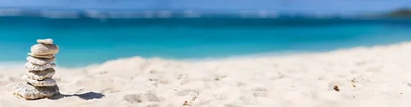 Panoramic photo of  stack of white corals on tropical beach