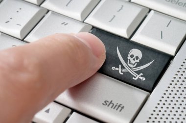 Online Pirating concept male finger pressing pirate icon enter key on metallic keyboard clipart