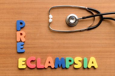 Pre-eclampsia  colorful word on the wooden background clipart