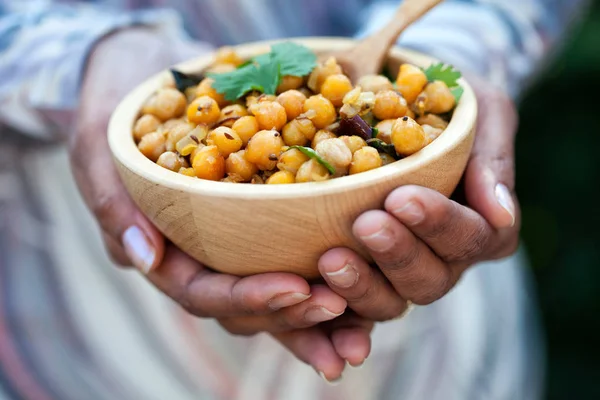 Female hands holding a bowl of chickpeas