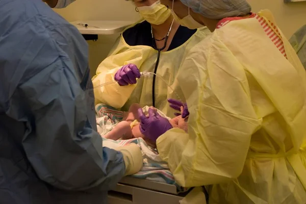 Πενεοτινοί Εξετάζουν Νεογέννητο Στο Χειρουργείο Κατά Διάρκεια Της Τομής — Φωτογραφία Αρχείου