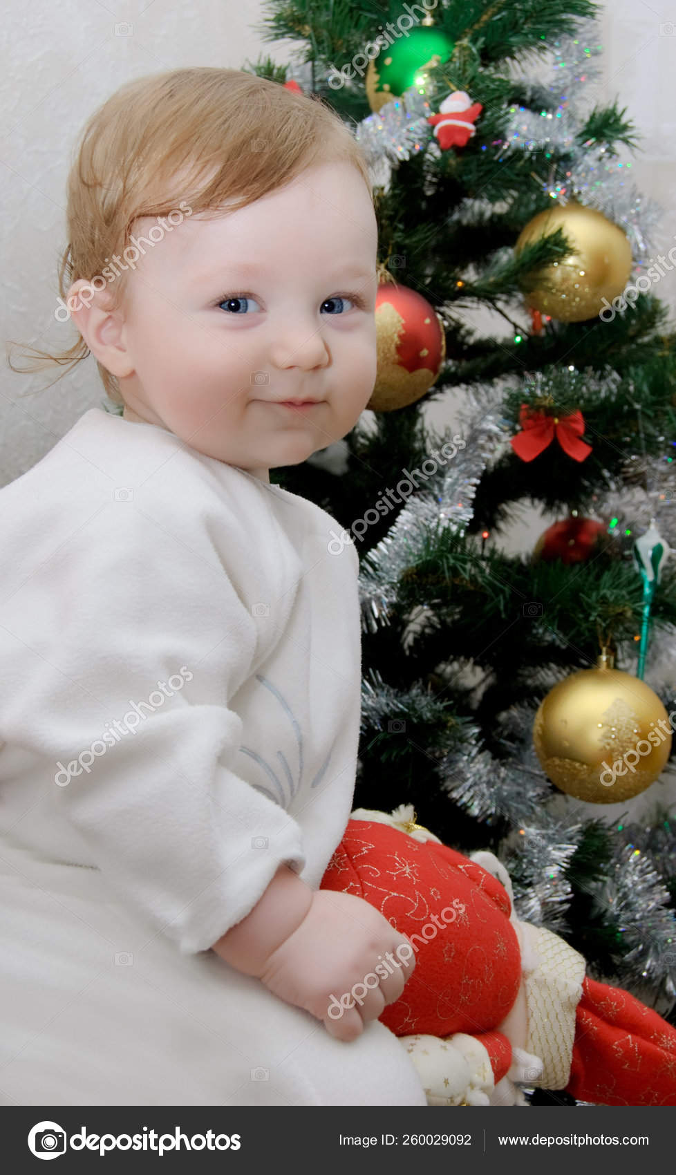 Adorable Baby Boy Christmas Tree Background Stock Photo by ©YAYImages