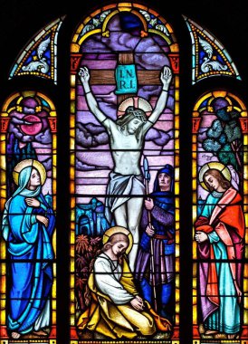 Stained glass church window depicting the crucifixtion of Christ clipart