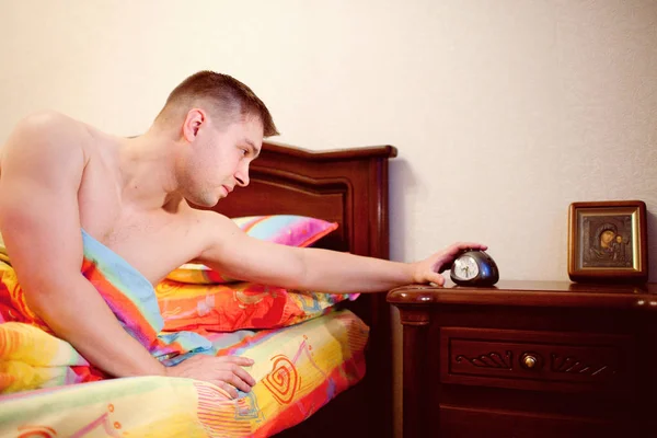 Man Bed Switching Alarm Clock — Stock Photo, Image