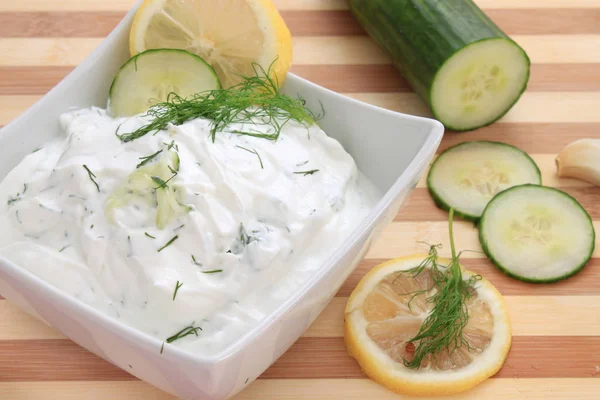 Tzatziki sauce made with yogurt, cucumbers, dill and lemon in a bowl