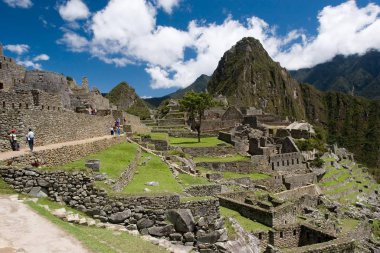 Machu Picchu (Old Peak) is pre-Columbian Inca site on mountain ridge above the Urubamba Valley in Peru clipart