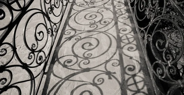 Handrail makes abstract shadows on porch in kremlin