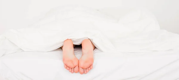 Δύο Λευκά Πόδια Ένα Κρεβάτι — Φωτογραφία Αρχείου
