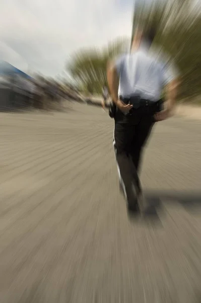 Running Policeman Reaching His Handcuffs Motion Blur — Stock Photo, Image