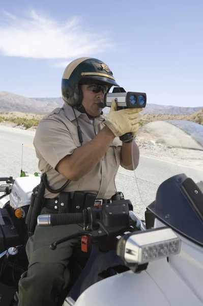 Cop Monitoring Speed Though Radar Gun