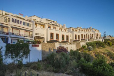 Apartamentos Os Descobrimentos is a beautiful family run complex of self catering apartments and villas in the picturesque fishing village of Burgau, Portugal. clipart