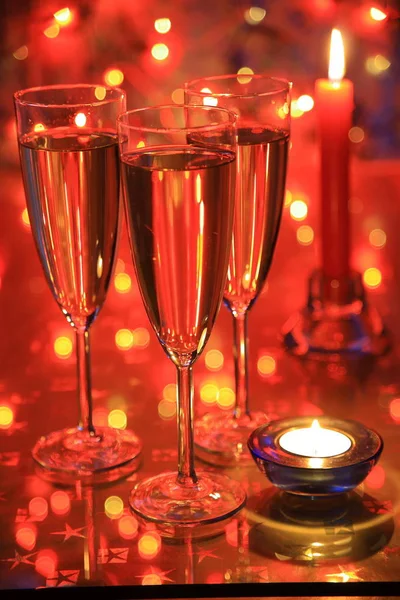 Champagne Glasses Candle Blured Lights Red Background — Stock Photo, Image