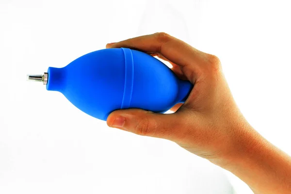 hand with air blower for cleaning camera