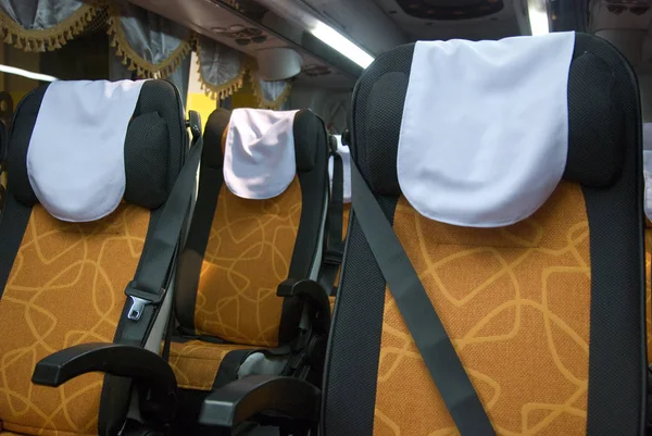 Interior of luxury tour bus with safety belts on each seat