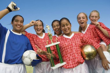 Female Soccer Team Holding Trophy clipart