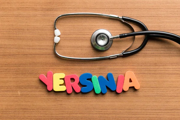 Yersinia Colorful Word Stethoscope Wooden Background — Stock Photo, Image