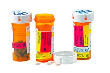 Three bottles of medicine with child proof caps clipart