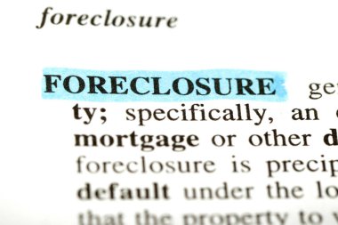 Highlighted definition of the word foreclosure  from a legal dictionary clipart