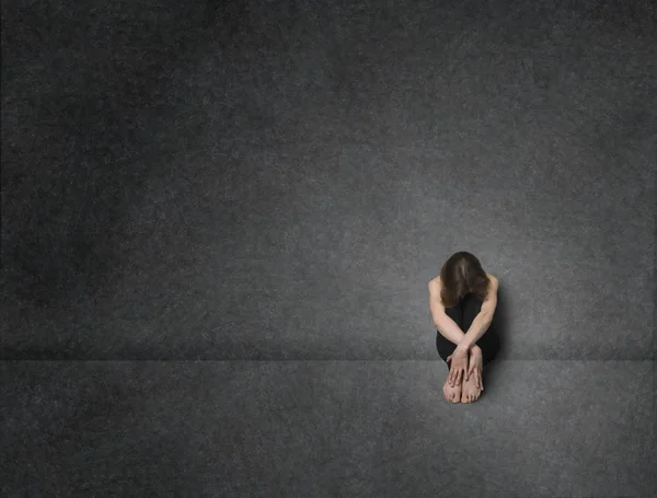 Sad Woman Sitting Floor Concrete Wall Studio Shot — Stock Photo, Image