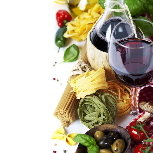 Italian food and wine. Ingredients for cooking (pasta, tomatoe, garlic, pepper, mushroom, bay leaves, olives, olive oil, basil)  over white