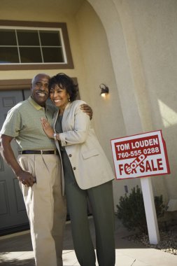 Couple Standing In Front Of New House clipart