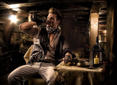 Handsome Rugged Male Pirate Drinking from Bottle in Ship Quarters clipart
