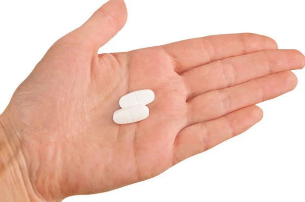Deux Pilules Blanches Sur Une Main Isolée Sur Fond Blanc — Photo