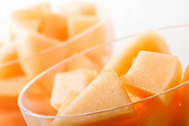cantaloupe cut and in parfait glass light background clipart