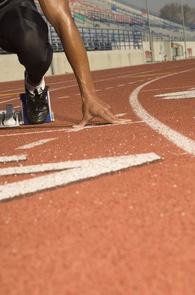 Male Athlete At Starting Line Ready To Race