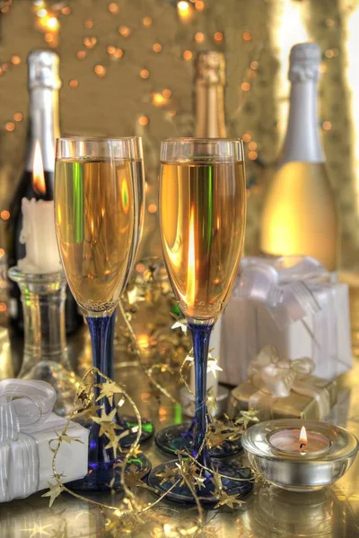 Champagne Glasses Bottles Gifts Candle Light Blurred Lights Gold Background — Stock Photo, Image