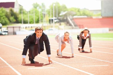 Businessmen running on track racing at athletich stadium clipart