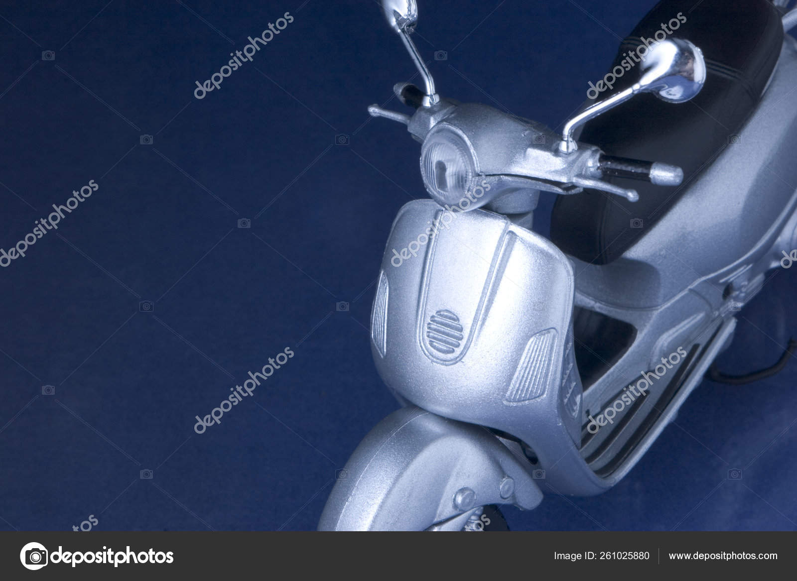 Toy Vespa Scooter Hovering Blue Reflecting Surface Stock Photo by ©YAYImages 261025880