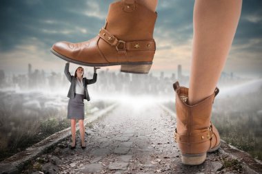 Composite image of cowboy boots stepping on businesswoman against stony path leading to large city on the horizon clipart