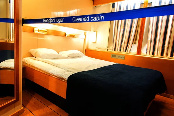 Interior of a living cabin on a cruise ship - with Cleaned cabin sign