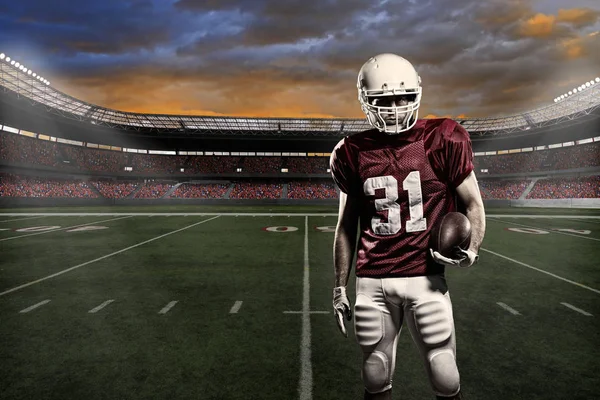 Football player with a red uniform, in a stadium with fans wearing red uniform