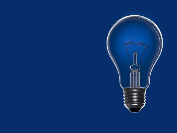 Turned off light bulb over a blue background. Copy space.