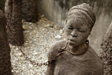 A statue in Stone Town. Zanzibar dipicting and mourning the African slave trade clipart