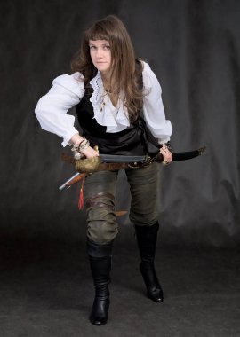 The girl - pirate with a sabre in hands on a black background clipart