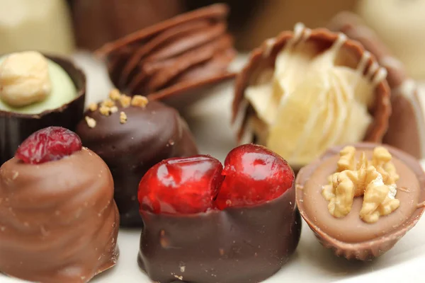 Luxury belgium chocolate pralines, decorated with fruits and nuts