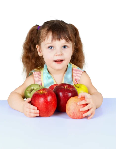 テーブルに座ってリンゴと遊ぶ少女 — ストック写真