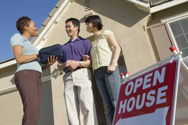 Couple Having Discussion With Female Estate Agent