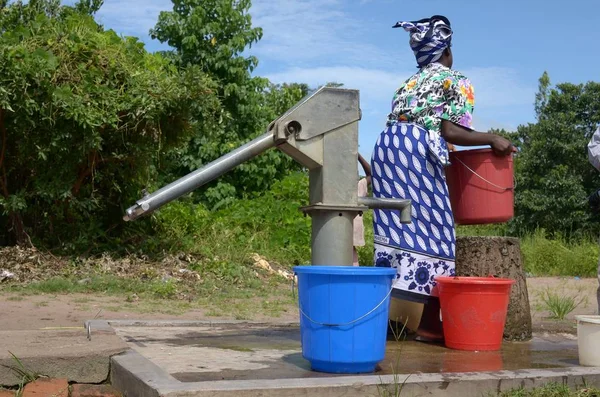 African woman with water in buckets