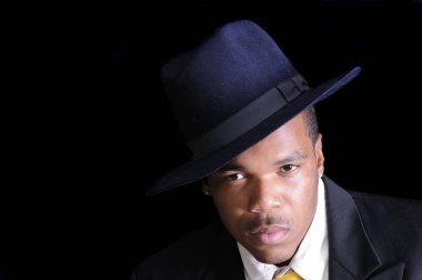 young African American man in a hat and suit clipart