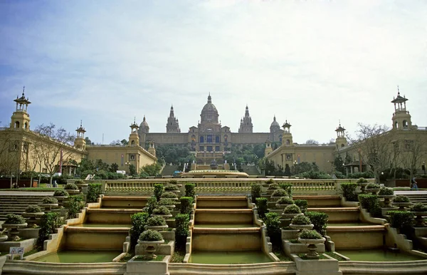 View of the Royal Palace in Barcelona, Spain, with its magnificent water feature and gardens in the early morning mist.