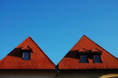 red Roofs against blue sky  clipart